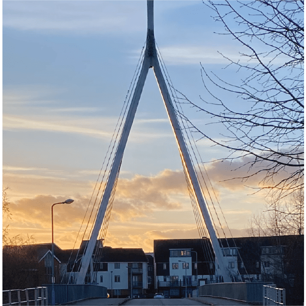 Broughton Bridge with a sunset behind it showing an orange glow